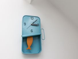 A wall clock with fish decoration at Beachfront in Whitby
