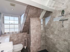 A bathroom with a sink, toilet, and shower at Beachfront in Whitby