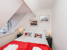 A bedroom with a bed and artwork at Beachfront in Whitby