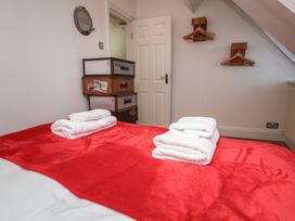 A bedroom with a bed and towels at Beachfront in Whitby