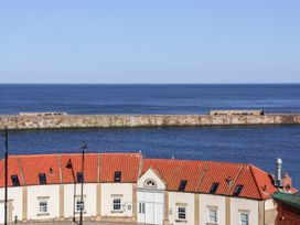 A view of the sea and pier from a building at Beachfront Whitby