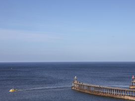 A view of a pier and a boat on the ocean at Beachfront in Whitby