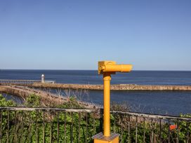 A viewing telescope overlooking the ocean at Beachfront Whitby
