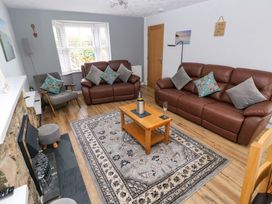 A living room with sofas and a coffee table at Ty'r Winllan in Newport, Pembrokeshire
