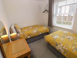 A bedroom with two beds and a desk at Ty'r Winllan in Newport, Pembrokeshire