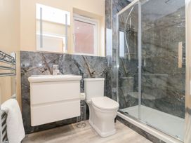 A bathroom with a sink, toilet, and shower at Quayside Haven in Whitby