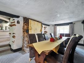 A dining room with a table and chairs at The Old Church House in Torbryan
