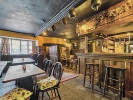 A pub interior with bar and tables at The Old Church House in Torbryan
