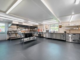 A kitchen with cooking appliances and utensils at The Old Church House in Torbryan