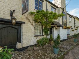 An outdoor view of a building with a door, windows and plants at The Old Church House in Torbryan