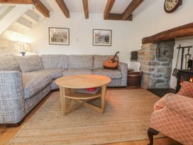 A living room with a sectional sofa and coffee table at Kernyk in Rinsey near Porthleven