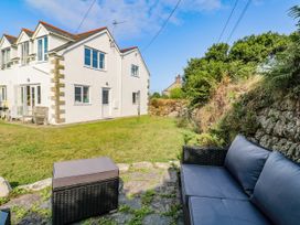 A garden area with a sofa and table at Kernyk in Rinsey near Porthleven