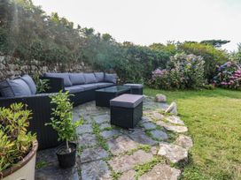 A garden with a seating area and plants at Kernyk in Rinsey near Porthleven