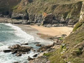 A beach with waves and rocks at Kernyk in Rinsey near Porthleven
