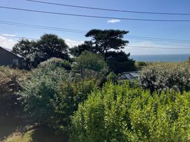 A garden with trees and a greenhouse at Kernyk in Rinsey near Porthleven