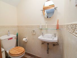 A bathroom with a sink and toilet at Ash Farm Cottage Lixwm near Caerwys