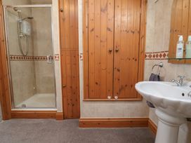 A bathroom with a shower and basin at Ash Farm Cottage in Lixwm near Caerwys