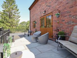 An outdoor area with seating and plants at Ash Farm Cottage in Lixwm near Caerwys