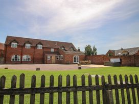 An outdoor area with a house, garden furniture, and a hot tub at Hunters Moon in Tenbury Wells
