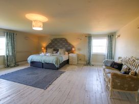 A bedroom with a bed and a sofa at Hilltop House in Tenbury Wells