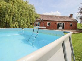 A swimming pool with a ladder at Hilltop House in Tenbury Wells