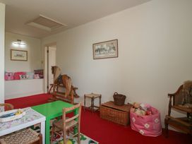 A playroom with a rocking horse and a colorful table at Hilltop House in Tenbury Wells