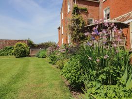 Garden with flowers and grass at Hilltop House in Tenbury Wells