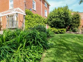 A garden with grass and plants at Hilltop House in Tenbury Wells