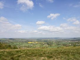 A landscape view of fields and hills under a cloudy sky at The Chestnuts in Tenbury Wells