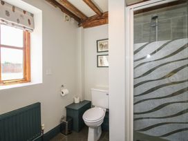 A bathroom with a toilet and shower at The Chestnuts in Tenbury Wells
