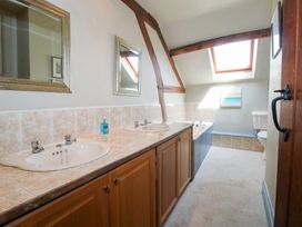 A bathroom with sinks and a bath tub at The Chestnuts in Tenbury Wells