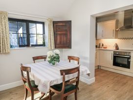 A kitchen with a table and chairs at Keepers Cottage in West Knoyle