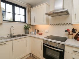 A kitchen with sink and stove at Keepers Cottage in West Knoyle