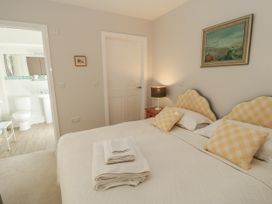 A bedroom with a bed and adjoining bathroom at Keepers Cottage in West Knoyle