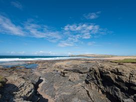 A beach with rocks and ocean at Beachcomber Padstow