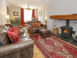 A living room with a sofa and fireplace at Sygun View in Beddgelert
