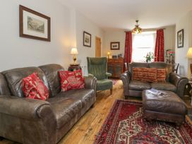 A living room with a sofa and armchair at Sygun View in Beddgelert