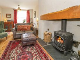 A living room with a fireplace and seating arrangements at Sygun View in Beddgelert