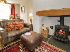 A living room with a sofa and fireplace at Sygun View in Beddgelert
