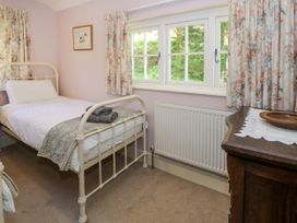 A bedroom with a bed and a table at Sygun View in Beddgelert