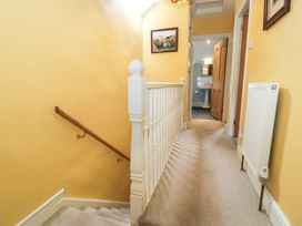 A hallway with stairs and a door at Sygun View in Beddgelert