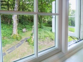 A view from a window showing a garden with a bench at Sygun View in Beddgelert