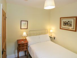 A bedroom with a bed and nightstand at Sygun View in Beddgelert