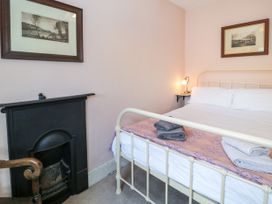 A bedroom with a bed and fireplace at Sygun View in Beddgelert