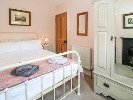 A bedroom with a bed and wardrobe at Sygun View in Beddgelert