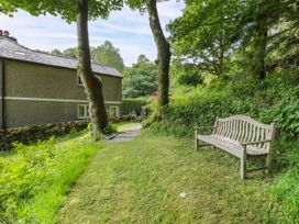 An outdoor area with a bench and path near a house at Sygun View in Beddgelert