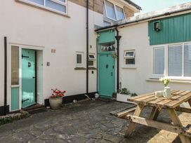 An outdoor area with a table and chairs at 4 Thornlea Mews in Hope Cove