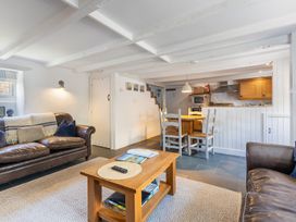 A living room with a sofa, table, and dining area at 3 Glendale Cottages Dittisham near Dartmouth