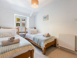 A bedroom with two beds and a window at 3 Glendale Cottages Dittisham near Dartmouth