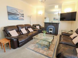 A living room with sofas and a coffee table at Preswylfa in Caernarfon